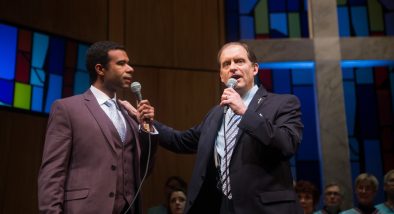 Associate Pastor Joshua (Lance Gardner*) and Pastor Paul (Anthony Fusco*) debate their differing interpretations of scripture.
