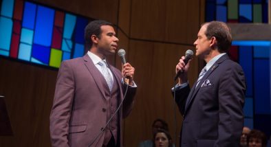 Associate Pastor Joshua (Lance Gardner*) and Pastor Paul (Anthony Fusco*) debate their differing interpretations of scripture.