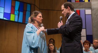 Jenny, a congregant (Millie Brooks), expresses reservations about Pastor Paul (Anthony Fusco*)'s latest sermon.