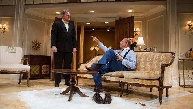 Harry Brock (Michael Torres*, right) makes demands of the hotel's Assistant Manager (Marty Lee Jones).