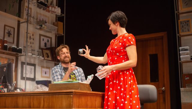 Lindsay (Jessica Lynn Carroll, right) shows an insect specimen to Jeff (Lucas Verbrugghe).