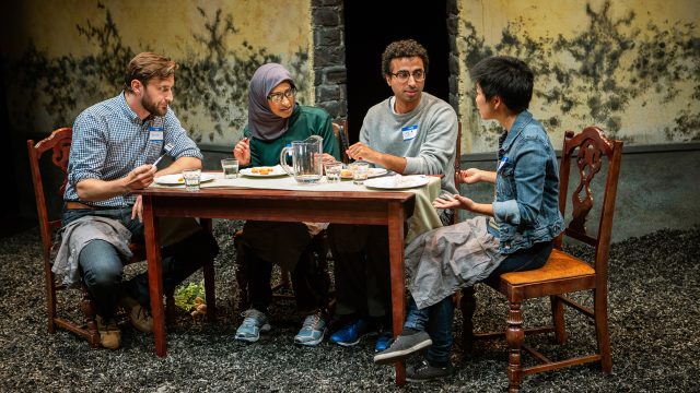 Justin (Josh Schell*, left) and Sarah (Sango Tajima, right) share dinner at their new inn with guests Soha (Sam Jackson) and Jai (Mohammad Shehata*).
