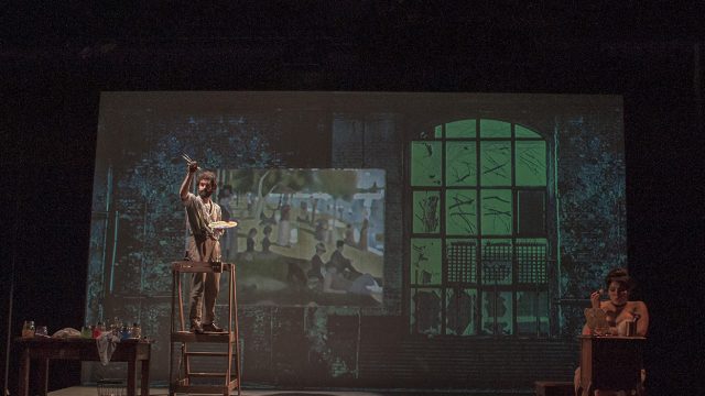 In his studio, George (John Bambery*) works on his masterpiece as Dot (Nanci Zoppi*) looks on.