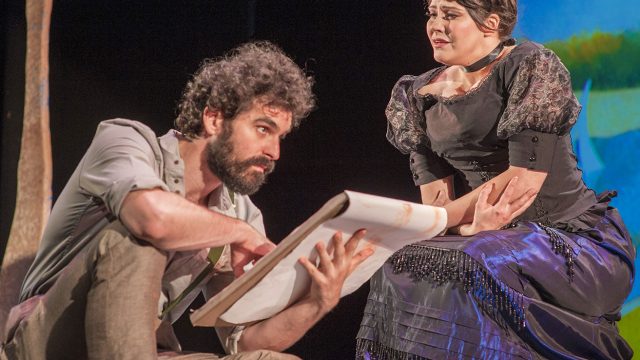 George (John Bambery*) sketches Dot (Nanci Zoppi*) in his studio.