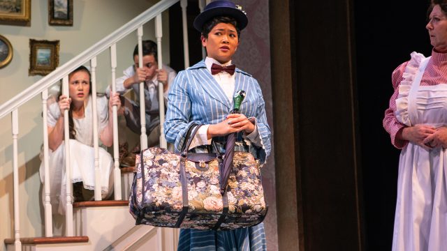 Mary Poppins (El Beh) arrives at Banks household, to the surprise of Jane Banks (Grace Hutton), Michael Banks (Billy Hutton) and Mrs. Bill (Marie Shell*).