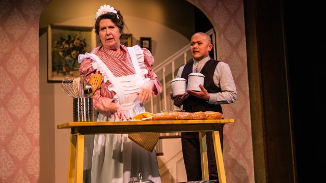 Mrs. Brill (Marie Shell*) and Robertson Ay (Rod Voltaire Edora*) tend to the Banks household.