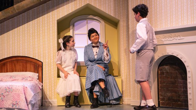 Mary Poppins (El Beh, center) teaches a lesson to Jane (Ruth Keith) and Michael Banks (David Rukin).