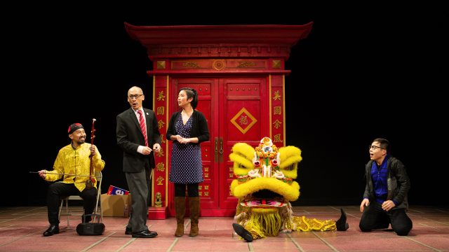 An erhu player (Jomar Tagatac*) watches Larry (Francis Jue*) and Lauren (Krystle Piamonte) discuss their family, as a lion dancer (Rinabeth Apostol*) and Danny Ma (Will Dao*) look on in 'King of the Yees' at San Francisco Playhouse.