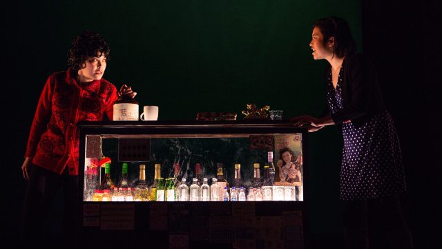 Lauren (Krystle Piamonte, right) visits a Whiskey Seller (Rinabeth Apostol*) in 'King of the Yees' at San Francisco Playhouse.