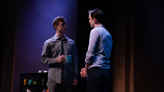 Jordan (Kyle Cameron*, right) introduces himself to the new guy at his office, Will (August Browning),