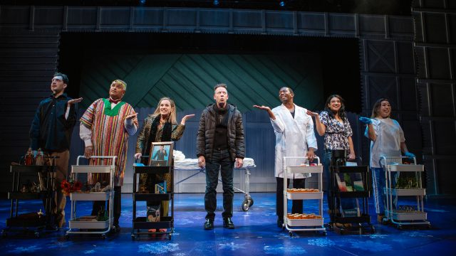 Phil (Ryan Drummond*, center) sees all the healers in town to figure out what is wrong with him. Featuring (l-r): Dean Linnard*, Michael Gene Sullivan*, Larissa Kelloway, Anthony Rollins-Mullens*, Sophia Introna*, and Danielle Philapil.