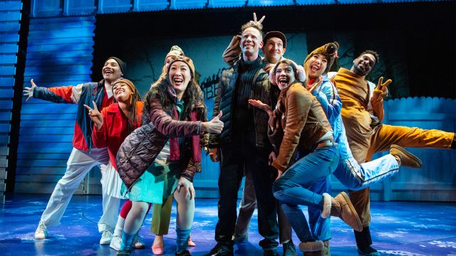 The residents of Punxsutawney are excited about Groundhog Day and Phil Connors' (Ryan Drummond*) reporting. Featuring (l-r): Jorge Luis Diaz, Loreigna Sinclair, Larissa Kelloway, Kathryn Hannah*, Ryan Drummond* (center), Dean Linnard*, Sophia Introna*, Danielle Philapil*, and Montel Anthony Nord.