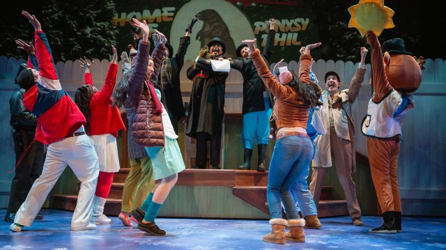 The residents of Punxsutawney, PA, are excited for Buster (Michael Gene Sullivan*) to announce the groundhog's prediction.