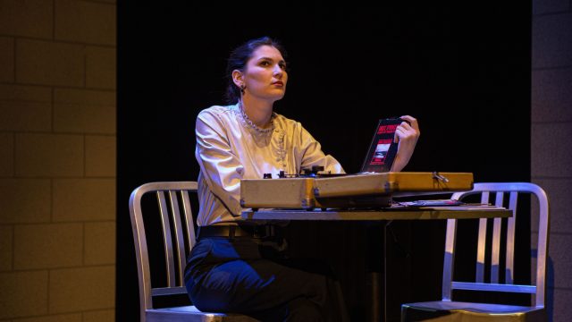 Lotte (Lauren Hart*) listens to Bruce Springsteen's records at home.