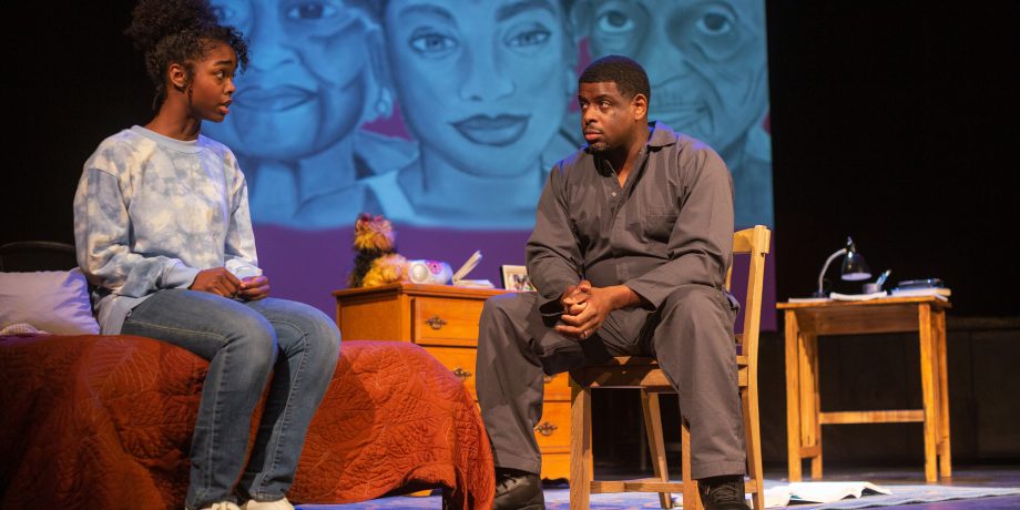 Davis Despenza Hayes (Jamella Cross*) and her father Ernest Hayes (Khary L. Moye*) talk about Davis’s grades at her new school.