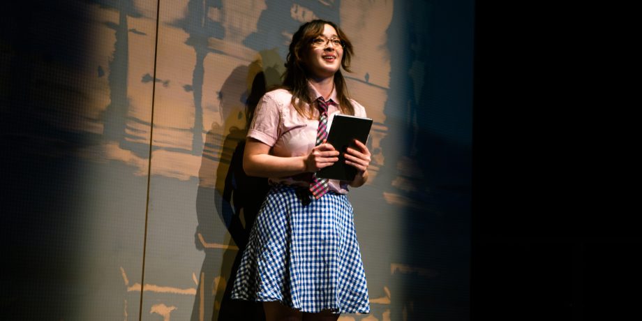 Gao-Ming (Kina Kantor*) gives a report to the audience--her history class--in 'The Great Khan' by Michael Gene Sullivan at San Francisco Playhouse.