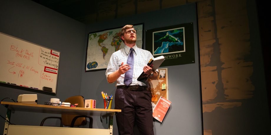 Mr. Adams (Adam KuveNiemann) works furiously on a piece of paper in 'The Great Khan' by Michael Gene Sullivan at San Francisco Playhouse.