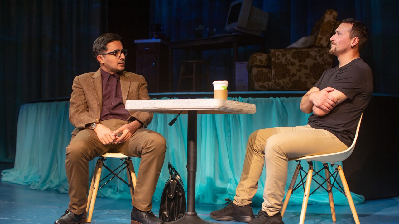 Professor Aman (Salim Razawi) discusses a job opportunity with Elliot Ortiz (Xander DeAngeles*) in 'Water by the Spoonful' at San Francisco Playhouse.