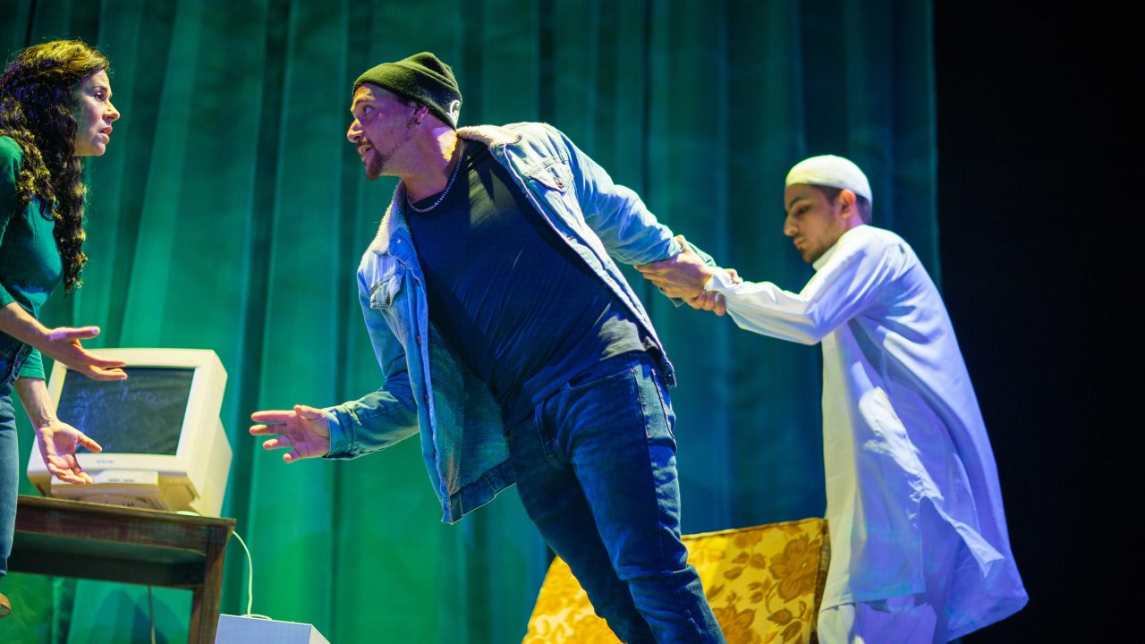 Yazmin Ortiz (Lara Maria*) pleads with her cousin Elliot Ortiz (Xander DeAngeles*) as he is held back by a ghost from his past (Salim Razawi) in 'Water by the Spoonful' at San Francisco Playhouse.