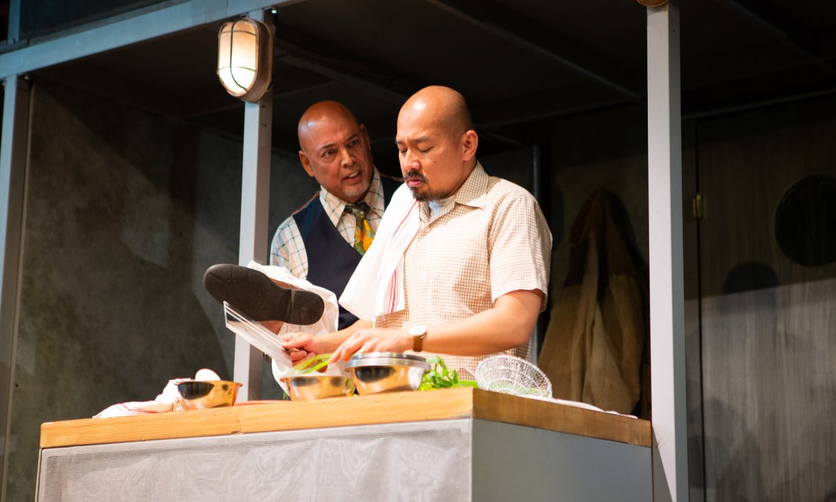 Boss (Michael Torres*) admonishes Harry (Jomar Tagatac*) for being distracted at work in 'The Paper Dreams of Harry Chin' at San Francisco Playhouse.