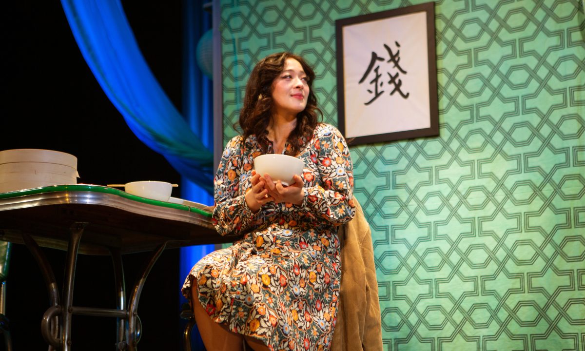 Sheila (Kina Kantor*) savors her father's cooking in 'The Paper Dreams of Harry Chin' at San Francisco Playhouse.