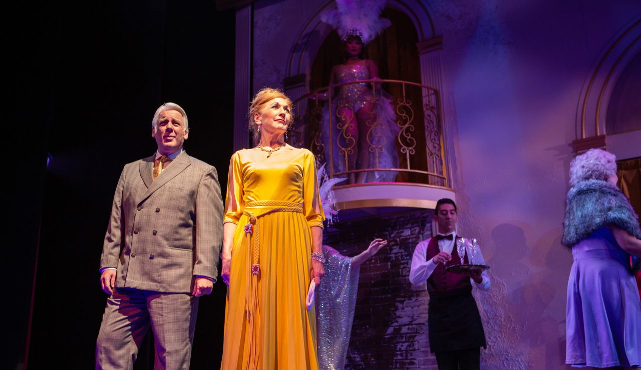 Benjamin Stone (Chris Vettel*) and Phyllis Rogers Stone (Maureen McVerry*) join Emily Whitman (Eiko Yamamoto, right) at the festivities, surrounded by the ghosts of Follies past (Catrina Manahan, balcony) and one of the evening’s waiters (M. Javi Harnly, in the back).