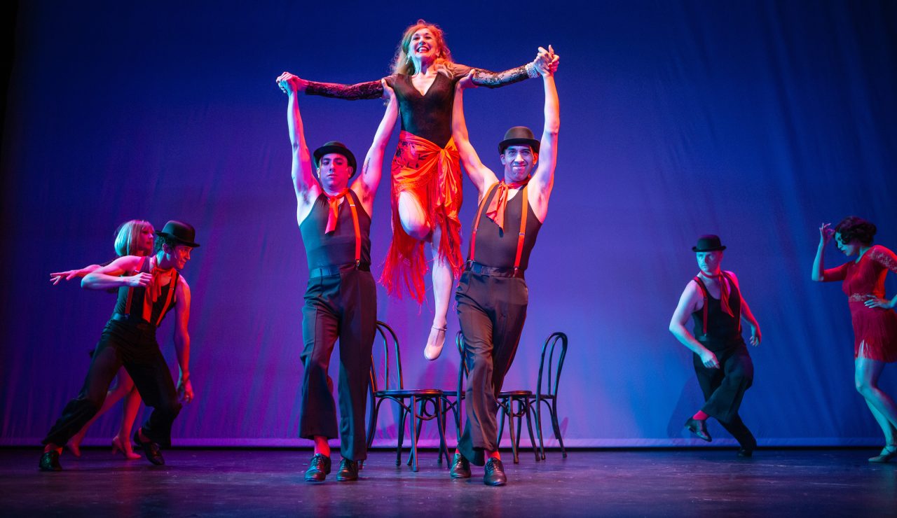 Phyllis Rogers Stone (Maureen McVerry*, center) reckons with life’s choices through 'The Story of Lucy and Jessie,' accompanied by (L-R) Jill Slyter, Chachi Delgado, Anthony Maglio, M. Javi Harnly, Cameron La Brie, and Ann Warque.