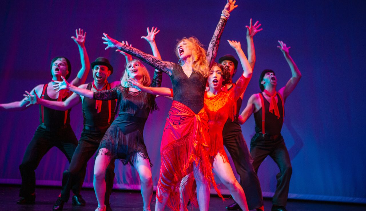 Phyllis Rogers Stone (Maureen McVerry*, center) reckons with life’s choices through 'The Story of Lucy and Jessie,' accompanied by (L-R) Cameron La Brie, Anthony Maglio, Jill Slyter, Ann Warque, Chachi Delgado, and M. Javi Harnly.