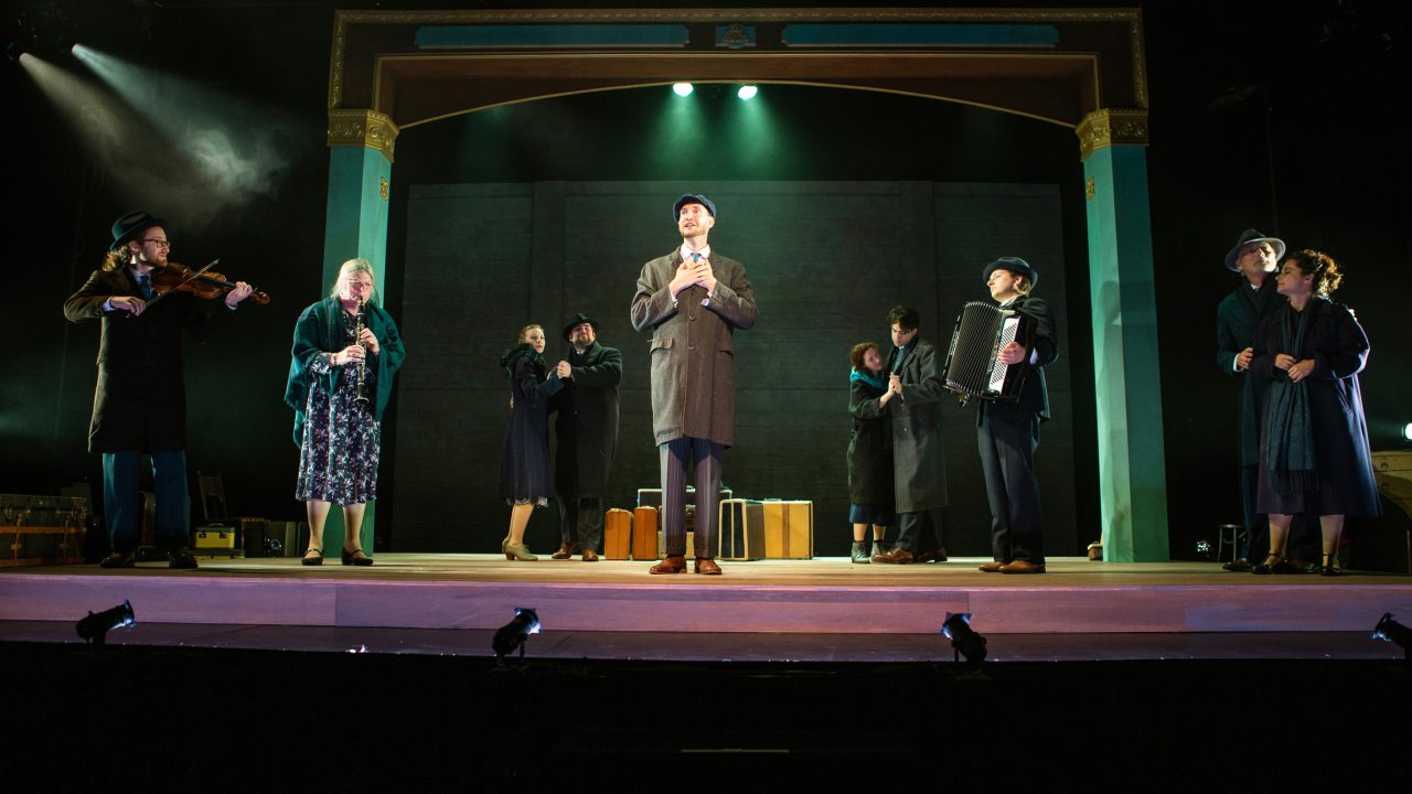 Lemml (Dean Linnard*, center) introduces the troupe (L-R): Mayer Balsam (Matthew Stein), on violin , Nelly Friedman (Audrey Jackson), on clarinet, Halina (Rivka Borek*), Mendel (Ted Zoldan), Chana (Malka Wallick*), Avram (Billy Cohen*), Moriz Godowsky (Dmitri Gaskin), on accordion, Otto (Victor Talmadge*), and Vera (Rachel Botchan*). Production photography by Jessica Palopoli for 'Indecent' by Paula Vogel at San Francisco Playhouse.