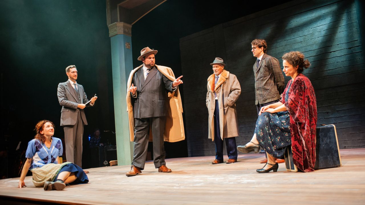 Chana as Virginia McFadden (Malka Wallick*, left), Lemml as Lou (Dean Linnard*, second from the left), Otto as Schildkraut (Victor Talmadge*, third from right), Avram as Moriz Carnovsky (Billy Cohen*, second from right), and Vera as Esther Stockton (Rachel Botchan*, right) assemble for a full company meeting with producer Harry Weinberger, played by Mendel (Ted Zoldan, center). 'Indecent' by Paula Vogel at San Francisco Playhouse.