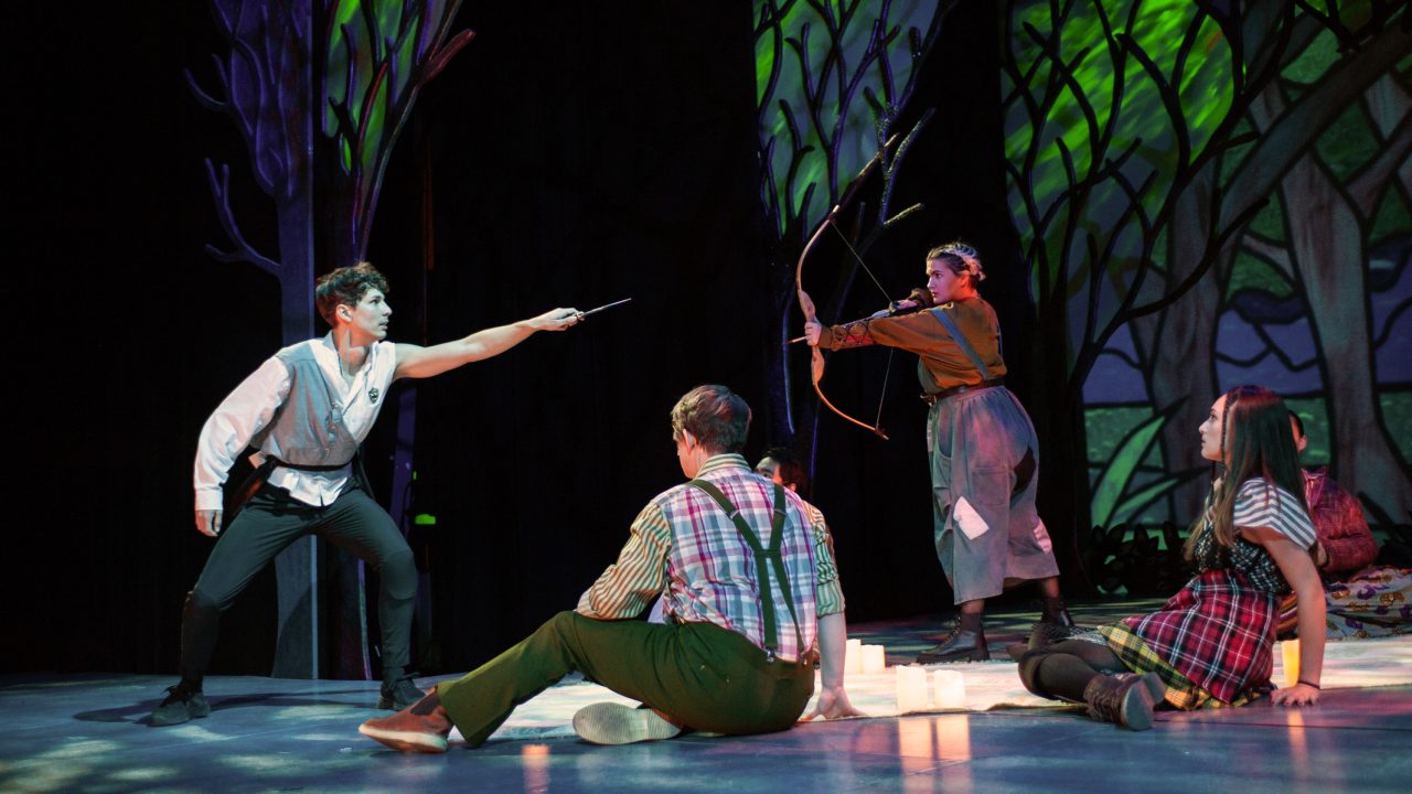 Orlando (Nikita Burshteyn) invades the forest community of Arden (l to r: Ezra Reaves, Emily Dwyer, Jillian A. Smith) in the forest of Arden in San Francisco Playhouse's musical version of "As You Like It," performing now through January 14, 2023.