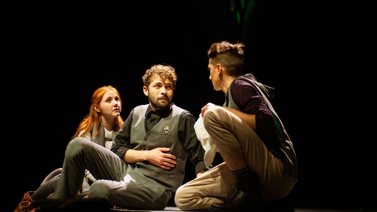 Celia (Abigail Esfira Campbell - left) and Rosalind (River Navaille – right) find an injured Oliver (Ryan Torres - center) in San Francisco Playhouse's musical version of "As You Like It," performing now through January 14, 2023.