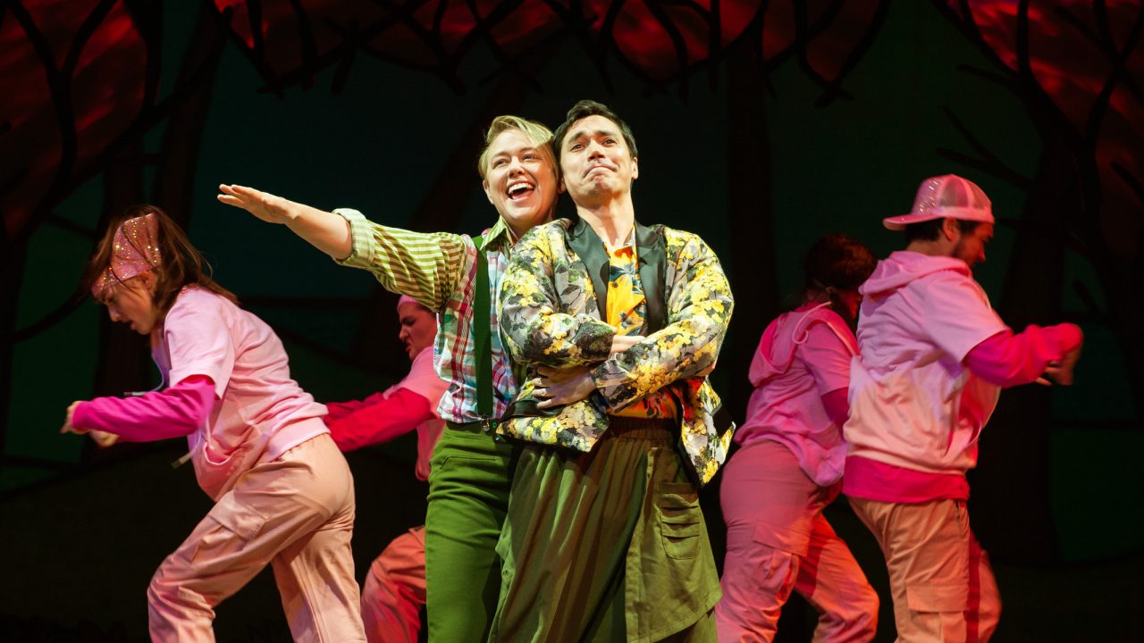 Andy (Ezra Reaves) and Touchstone (Nicholas Yenson) sing a love ballad accompanied by backup dancers in San Francisco Playhouse's musical version of "As You Like It," performing now through January 14, 2023.