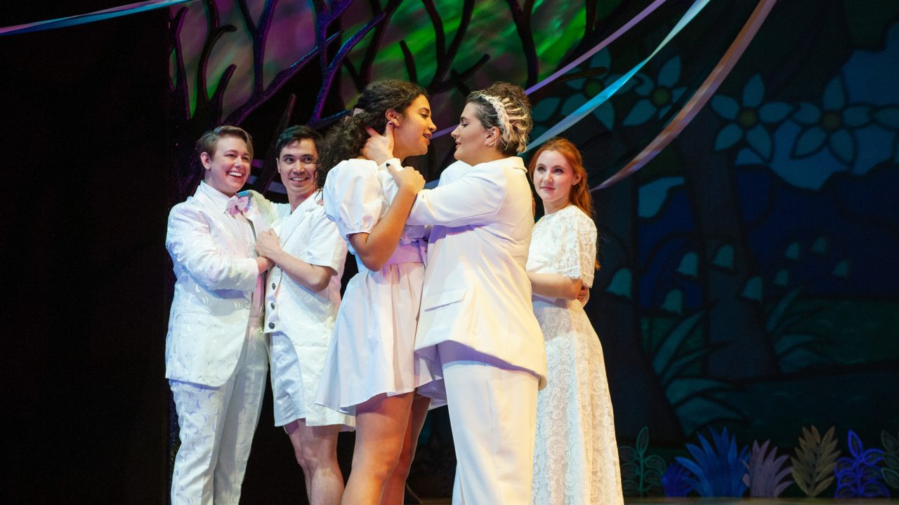 Couples (l to r: Ezra Reaves, Nicholas Yenson, Sophia Alawi, Emily Dwyer, Abigail Esfira Campbell) embrace in a quadruple wedding ceremony in San Francisco Playhouse's musical version of "As You Like It," performing now through January 14, 2023.