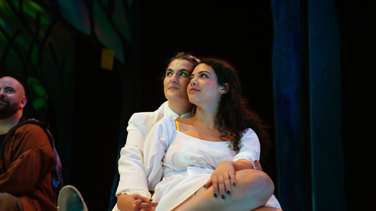 Phoebe (Emily Dwyer) and Silvia (Sophia Alawi) embrace in San Francisco Playhouse's musical version of "As You Like It," performing now through January 14, 2023.