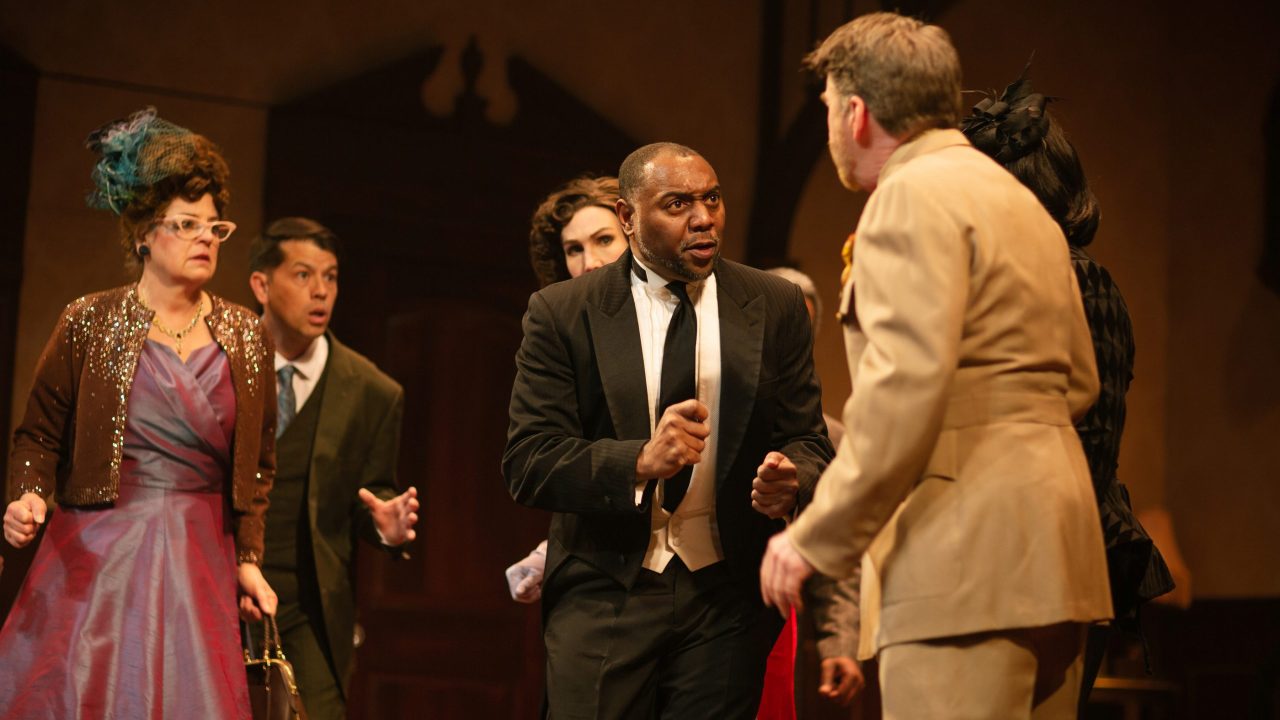 Mrs. Peacock (Stacy Ross), Mr. Green (Greg Ayers), and Mrs. Scarlet (Courtney Walsh) look on as Wadsworth (Dorian Lockett) reveals hidden secrets to Colonel Mustard (Michael Ray Wisely) and Mrs. White (Renee Rogoff) in San Francisco Playhouse's "Clue," performing March 9 - April 22.
