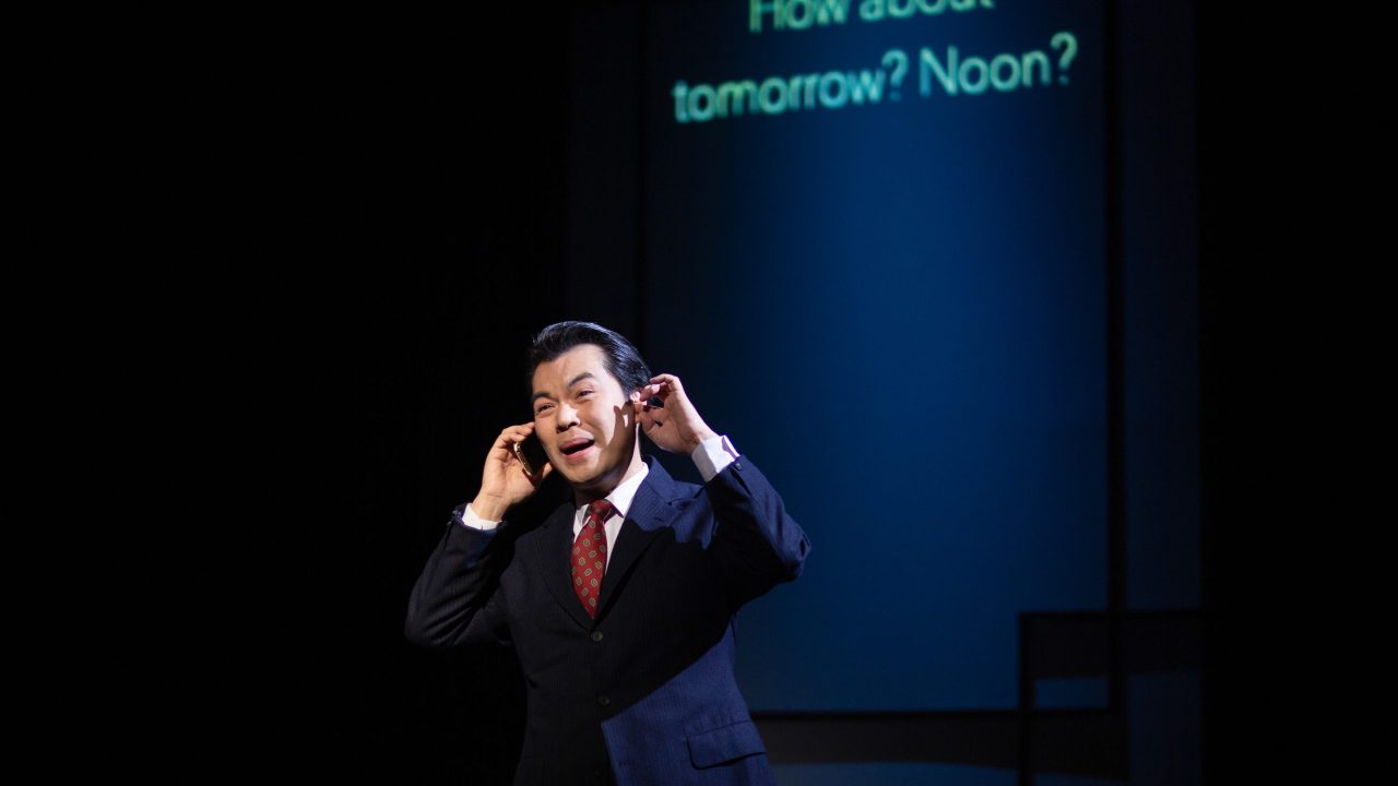 Minister of Culture Cai Guoliang (Alex Hsu) takes a call in San Francisco Playhouse's "Chinglish," performing May 4 - June 10.