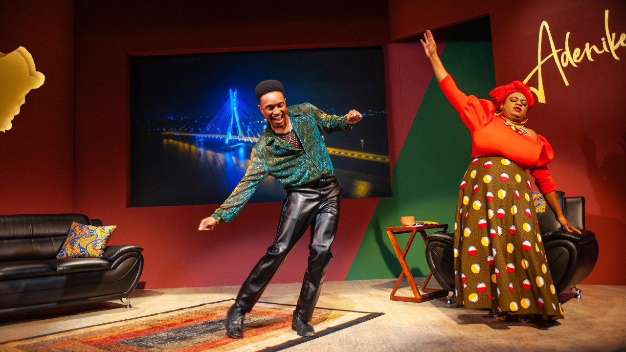 Wale (Jordan Covington) dances on Adenikeh's (Tanika Baptiste) talk show in San Francisco Playhouse's "Nollywood Dreams," performing September 28 - November 4, 2023.