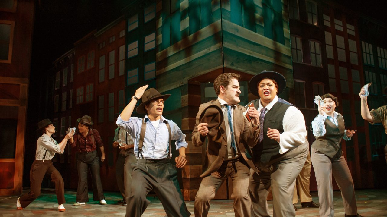 Gamblers (l to r: Jill Slyter, Malia Abayon, Jurä Davis, Chachi Delgado, Joel Roster, Kay Loren, Miles Meckling, Brigitte Losey) seek the place for their floating craps game in San Francisco Playhouse's "Guys and Dolls," performing November 16, 2023 - January 13, 2024.