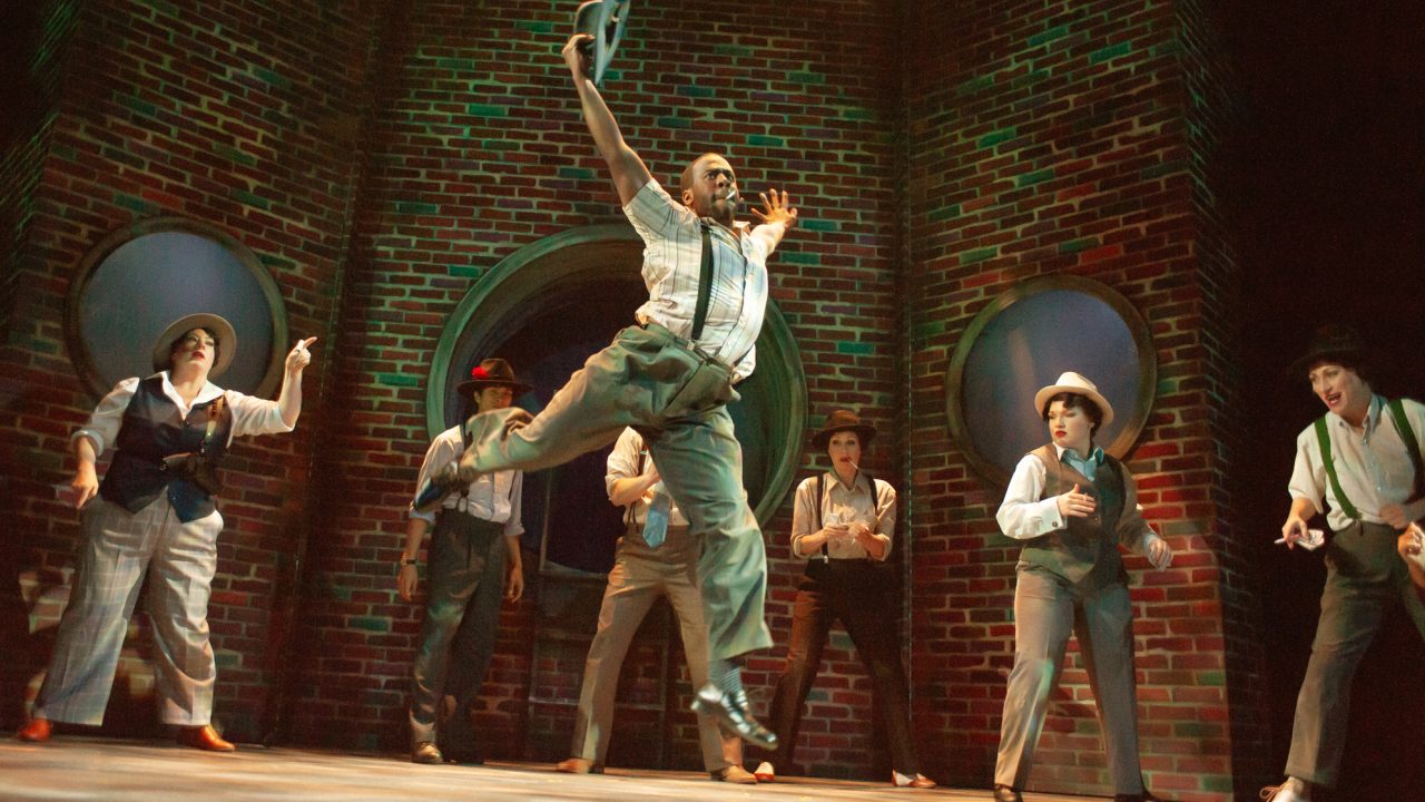 Crapshooters (l to r- Jessica Coker, Chachi Delgado, Jurä Davis, Joel Roster, Jill Slyter, Brigitte Losey, and Alison Ewing) hope for luck in San Francisco Playhouse's "Guys and Dolls," performing November 16, 2023 - January 13, 2024.