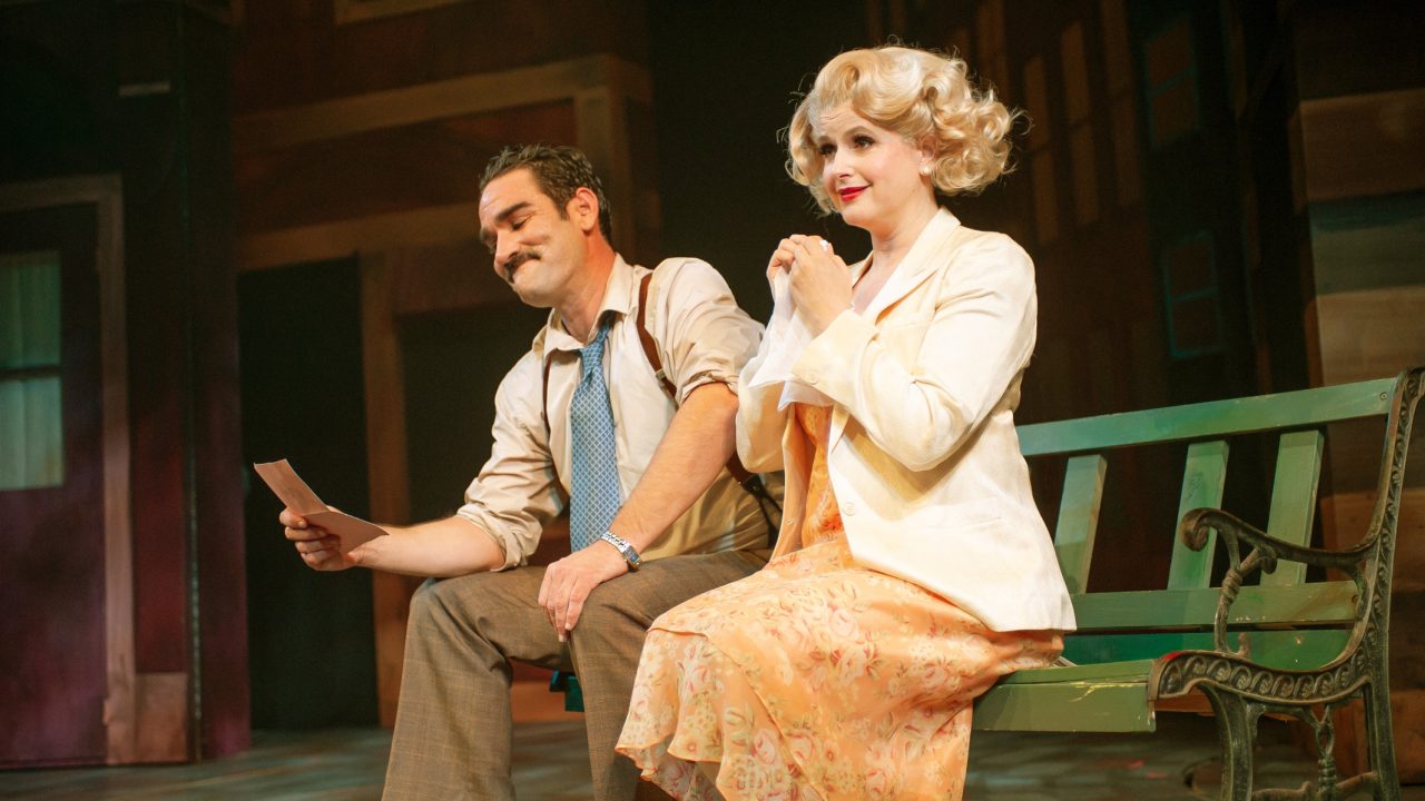 Nathan (Joel Roster) reads a letter as Adelaide (Melissa WolfKlain) schemes to get him to the altar in San Francisco Playhouse's "Guys and Dolls," performing November 16, 2023 - January 13, 2024.