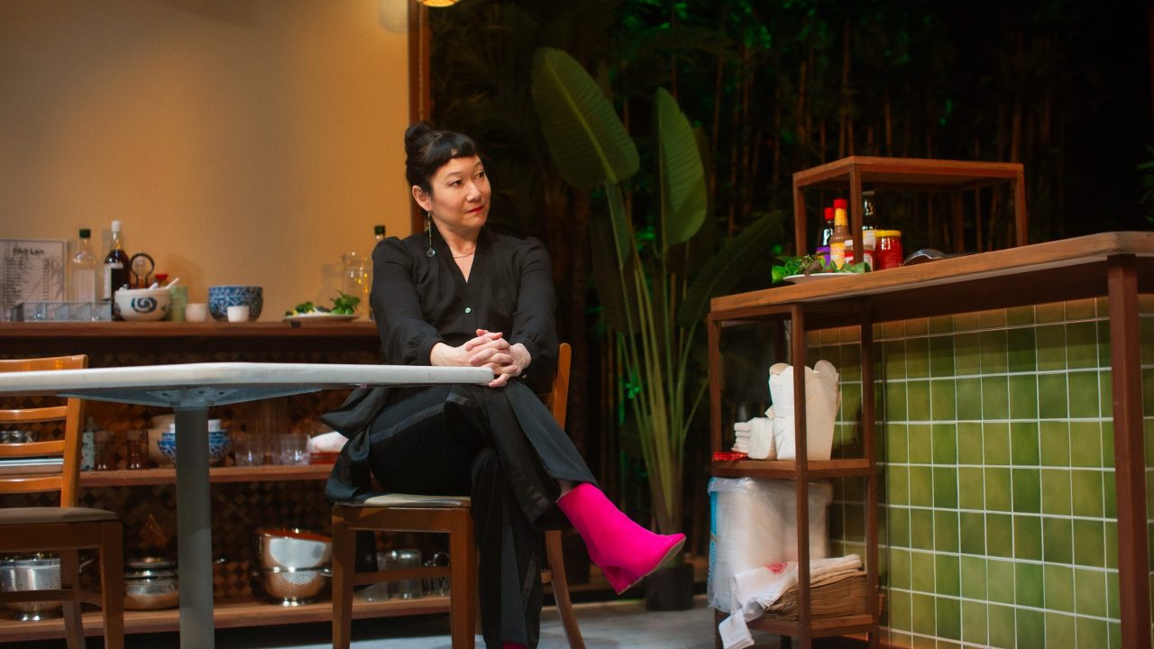 CEO Gigi (Erin Mei-Ling Stuart) visits the restaurant in San Francisco Playhouse's World Premiere Play "My Home on the Moon," performing January 25 - February 24.