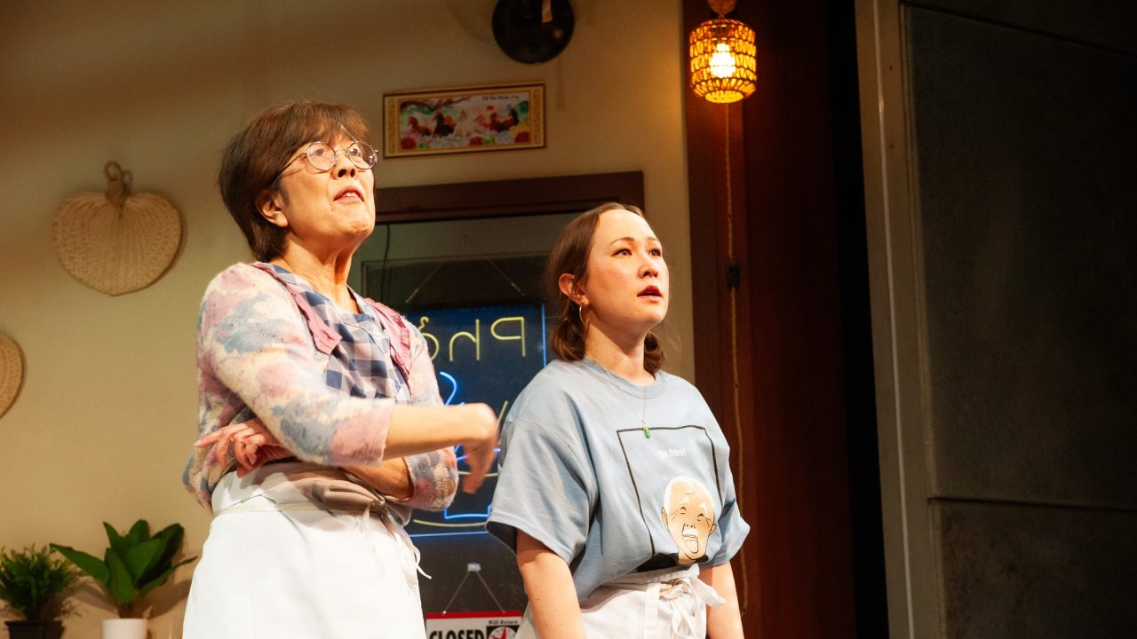 Lan (Sharon Omi) and Mai (Jenny Nguyen Nelson) struggle to keep their restaurant afloat in San Francisco Playhouse's World Premiere Play "My Home on the Moon," performing January 25 - February 24.