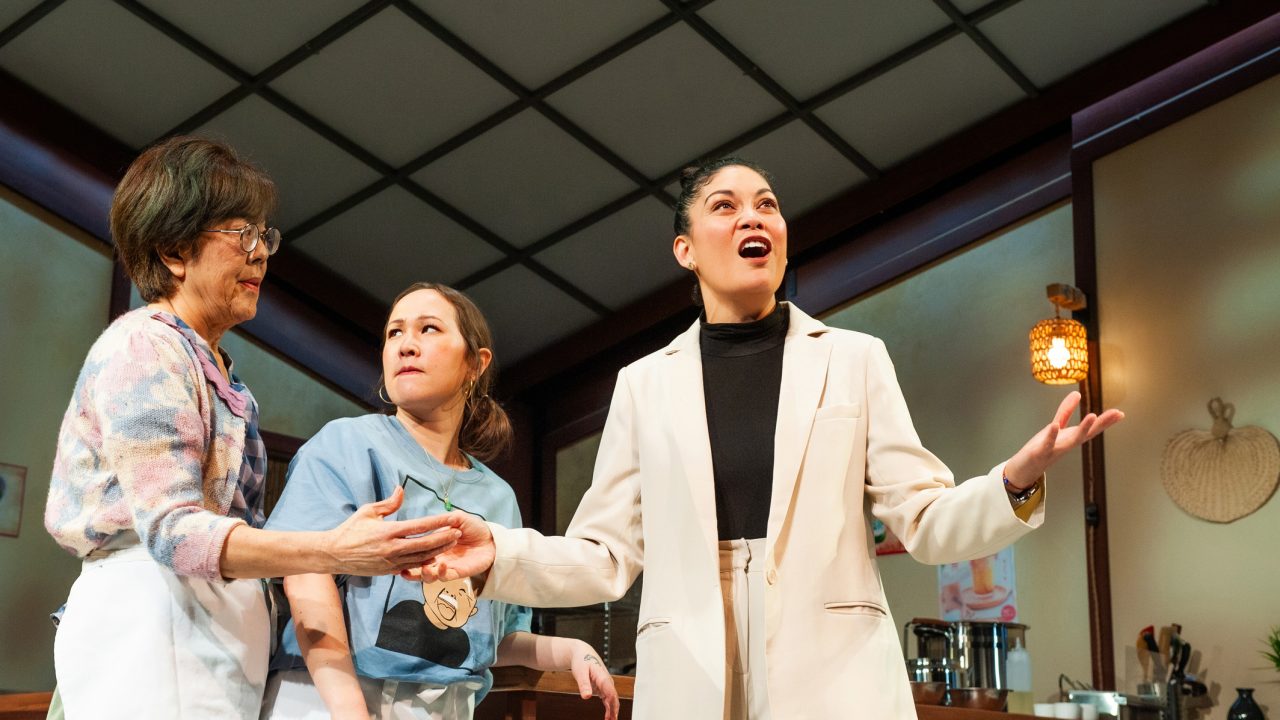 (L-R) Lan (Sharon Omi) and Mai (Jenny Nuygen Nelson) are taken aback by consultant Vera (Rinabeth Apolstol) in San Francisco Playhouse's World Premiere Play "My Home on the Moon," performing January 25 - February 24.