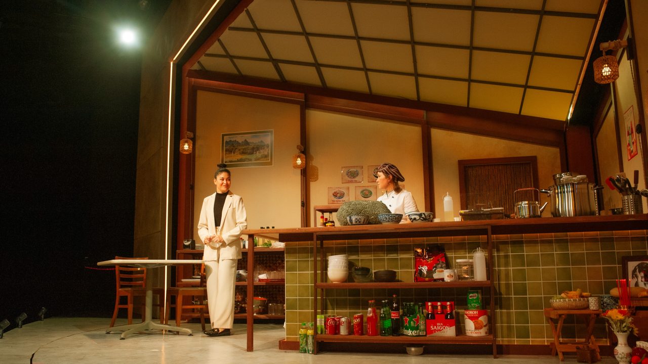 Vera (Rinabeth Apostol) discusses the restaurant with Mai (Jenny Nguyen Nelson) in San Francisco Playhouse's World Premiere Play "My Home on the Moon," performing January 25 - February 24.