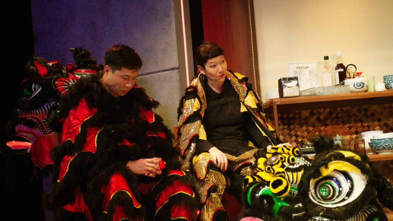 Lion dancers (Will Dao, Erin Mei-Ling Stuart) in San Francisco Playhouse's World Premiere Play "My Home on the Moon," performing January 25 - February 24.