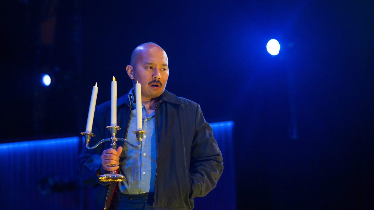 Tom (Jomar Tagatac) makes his way through a darkened room in San Francisco Playhouse's "The Glass Menagerie," performing May 2 - June 15.