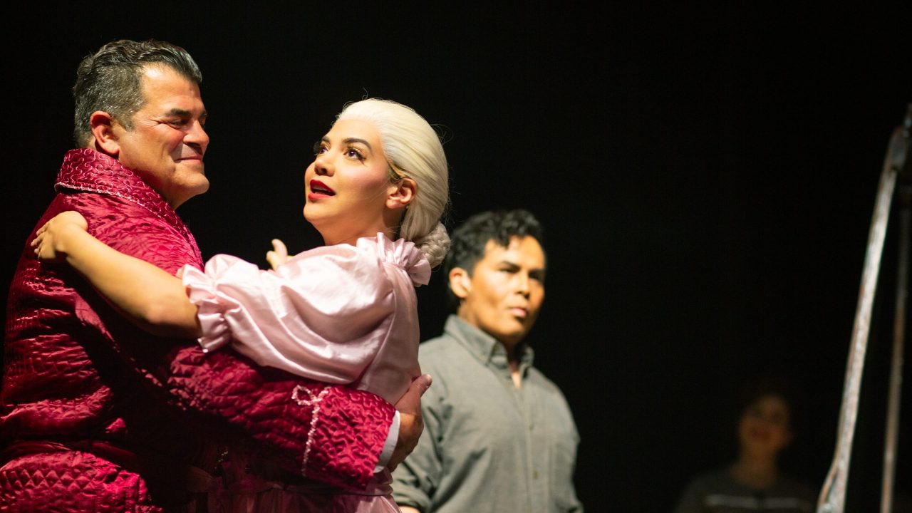 Juan Perón (Peter Gregus) dances with Eva Perón (Sophia Alawi) as Che (Alex Rodriguez) watches in San Francisco Playhouse's "Evita," performing June 27 - September 7, 2024. Juan Perón (Peter Gregus) dances with Eva Perón (Sophia Alawi) as Che (Alex Rodriguez) watches in San Francisco Playhouse's "Evita," performing June 27 - September 7, 2024.