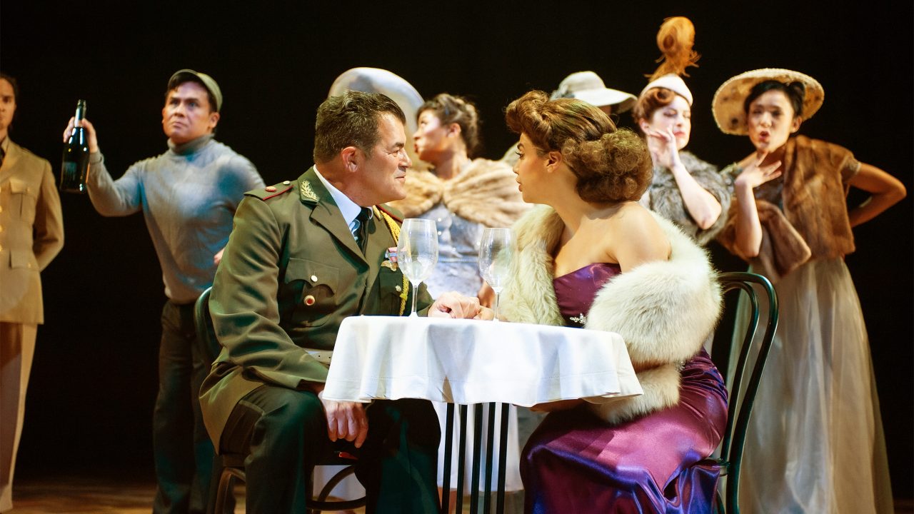 Juan Perón (Peter Gregus) is charmed by radio star Eva Duarte (Sophia Alawi) as Che (left - Alex Rodriguez) and the crowd look on in San Francisco Playhouse's "Evita," performing June 27 - September 7, 2024. Juan Perón (Peter Gregus) is charmed by radio star Eva Duarte (Sophia Alawi) as Che (left - Alex Rodriguez) and the crowd look on in San Francisco Playhouse's "Evita," performing June 27 - September 7, 2024.