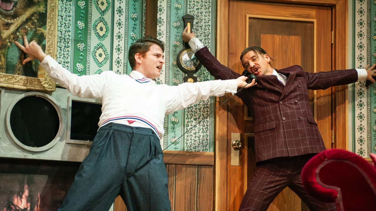 Max (Joe Ayers) helps Robert (Patrick Russell) with a call in "The Play That Goes Wrong," presented by San Francisco Playhouse September 21 - November 9. "The Play That Goes Wrong" production photo.